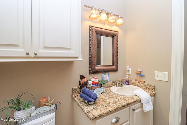 bathroom featuring toilet and vanity