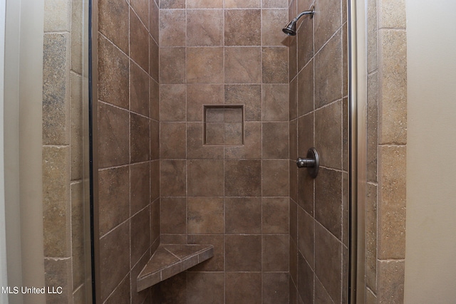 bathroom with a shower with door