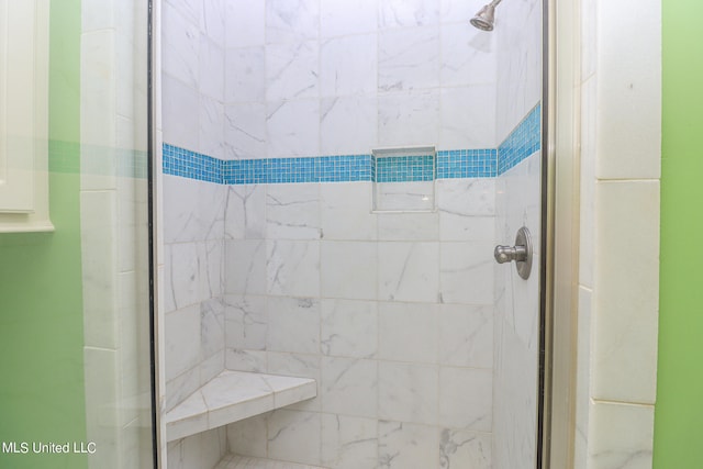 bathroom featuring a shower with door