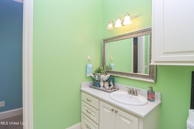 bathroom featuring vanity and toilet