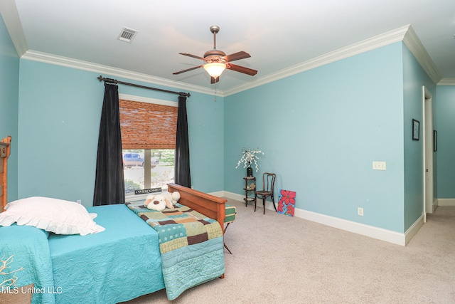 carpeted bedroom featuring ceiling fan and crown molding