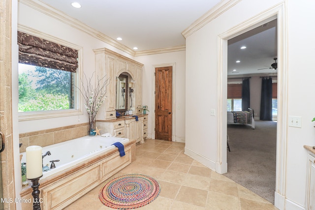 bathroom featuring vanity, a tub, ceiling fan, and ornamental molding