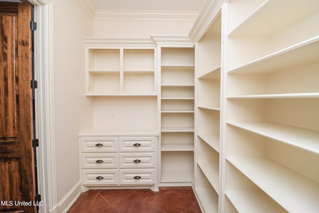 walk in closet featuring dark tile patterned floors