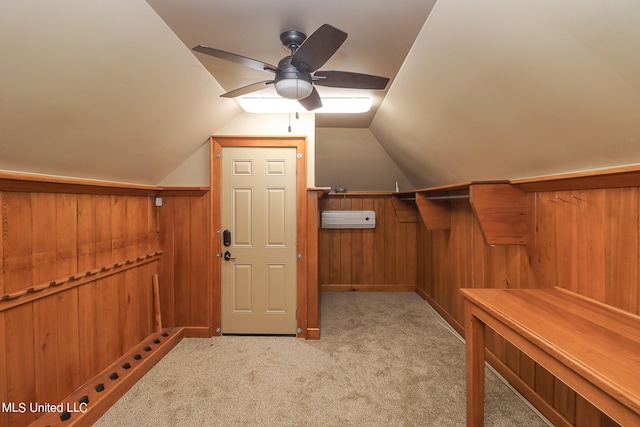 walk in closet with ceiling fan, light colored carpet, and vaulted ceiling