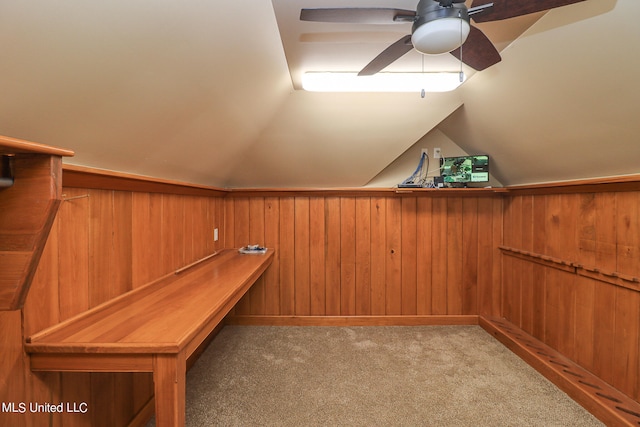 spacious closet with lofted ceiling, light colored carpet, and ceiling fan