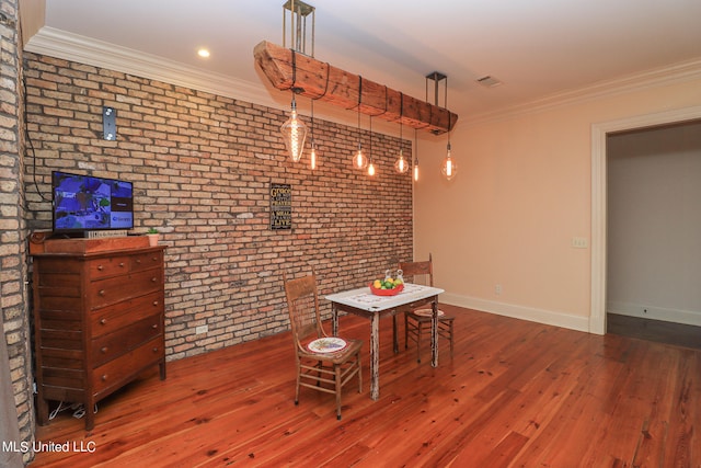 unfurnished dining area featuring brick wall, crown molding, and dark hardwood / wood-style flooring