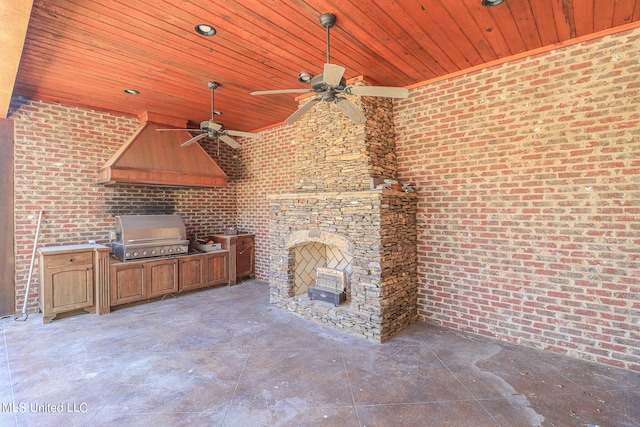 view of patio / terrace with an outdoor stone fireplace, exterior kitchen, grilling area, and ceiling fan