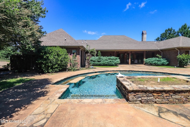 view of swimming pool with an in ground hot tub and a patio area