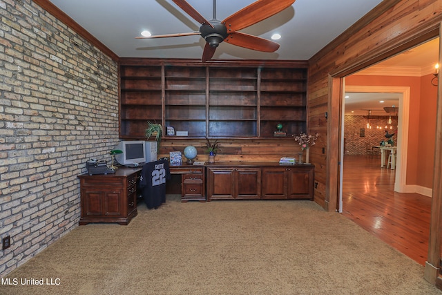 office space featuring crown molding, hardwood / wood-style flooring, brick wall, and ceiling fan