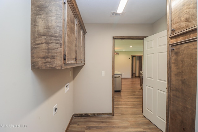 laundry area with hardwood / wood-style flooring, washer hookup, cabinets, and electric dryer hookup