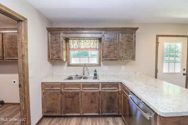 kitchen featuring dishwasher, dark brown cabinetry, sink, and hardwood / wood-style floors