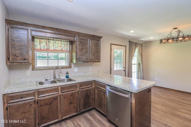 kitchen with stainless steel dishwasher, sink, hardwood / wood-style floors, and plenty of natural light