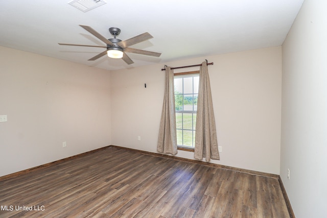 spare room featuring ceiling fan and dark hardwood / wood-style flooring