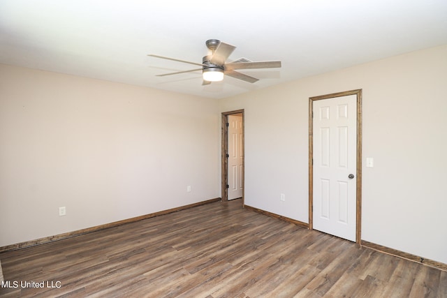 unfurnished room featuring dark hardwood / wood-style floors and ceiling fan