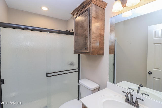 bathroom featuring vanity, toilet, and an enclosed shower