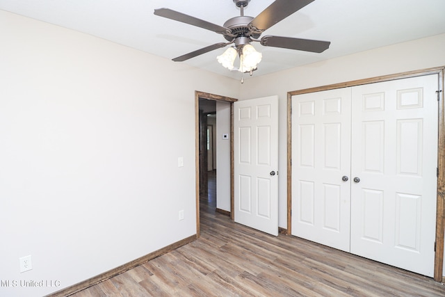 unfurnished bedroom featuring a closet, light wood-type flooring, and ceiling fan