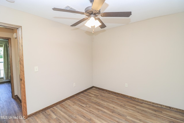 unfurnished room with hardwood / wood-style flooring and ceiling fan