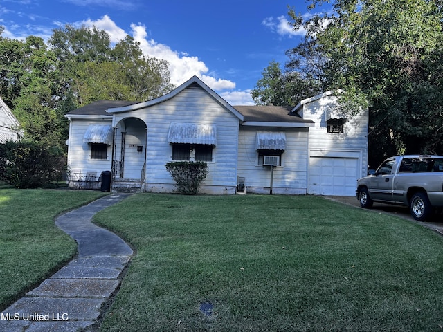 ranch-style house with a front yard, cooling unit, and a garage