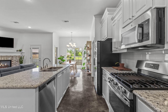 123 Bailey Cv, Canton, MS 39046 - kitchen featuring stainless steel appliances, a sink, decorative backsplash, concrete flooring, and a chandelier