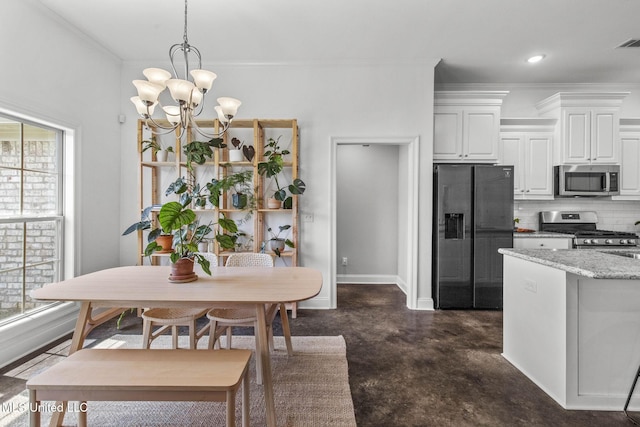 123 Bailey Cv, Canton, MS 39046 - dining space with ornamental molding, a chandelier, baseboards, and concrete floors