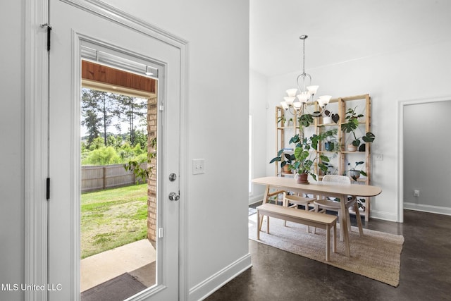 123 Bailey Cv, Canton, MS 39046 - entryway featuring finished concrete flooring, a chandelier, and baseboards