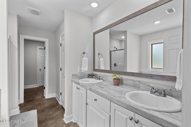 123 Bailey Cv, Canton, MS 39046 - full bath featuring a shower stall, finished concrete flooring, baseboards, and double vanity