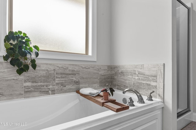 123 Bailey Cv, Canton, MS 39046 - bathroom featuring a bath and a shower stall