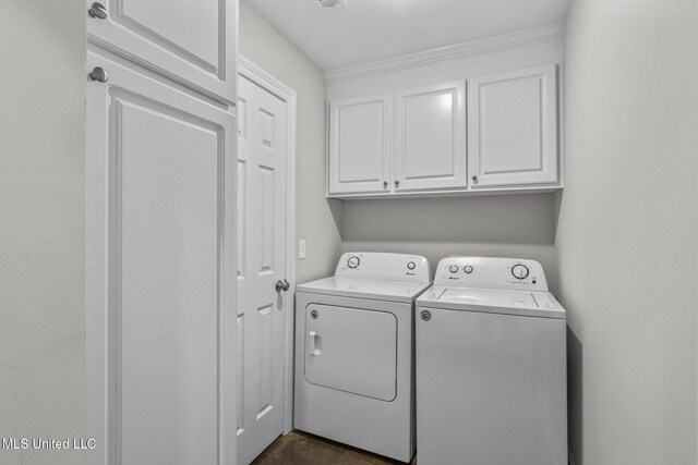123 Bailey Cv, Canton, MS 39046 - clothes washing area featuring separate washer and dryer and cabinet space