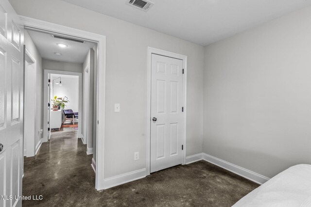 123 Bailey Cv, Canton, MS 39046 - unfurnished bedroom featuring concrete floors and baseboards