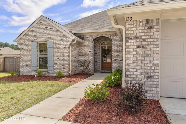 123 Bailey Cv, Canton, MS 39046 - doorway to property with brick siding and a shingled roof