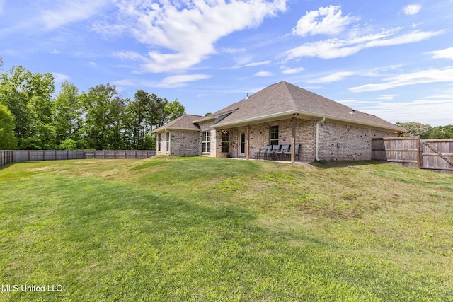 123 Bailey Cv, Canton, MS 39046 - back of house featuring brick siding, a patio area, and a shingled roof