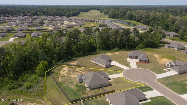 123 Bailey Cv, Canton, MS 39046 - aerial perspective of suburban area featuring property parcel outlined, a nearby body of water, and a forest