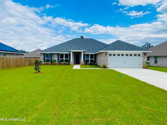 view of front of house featuring a garage and a front lawn