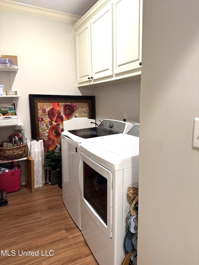 4 Bayou Ln, Natchez, MS 39120 - clothes washing area with cabinet space, independent washer and dryer, light wood finished floors, and crown molding