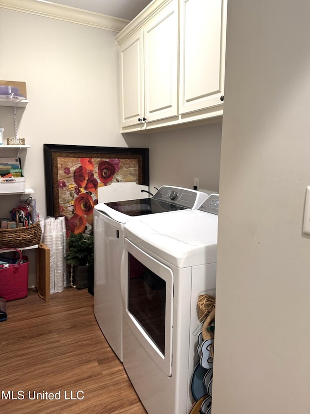 4 Bayou Ln, Natchez, MS 39120 - clothes washing area with cabinet space, independent washer and dryer, light wood-type flooring, and ornamental molding