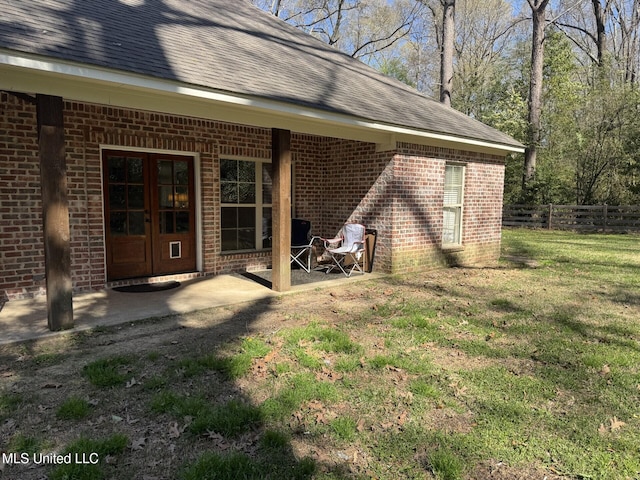 4 Bayou Ln, Natchez, MS 39120 - exterior space featuring fence, french doors, a yard, brick siding, and a patio area