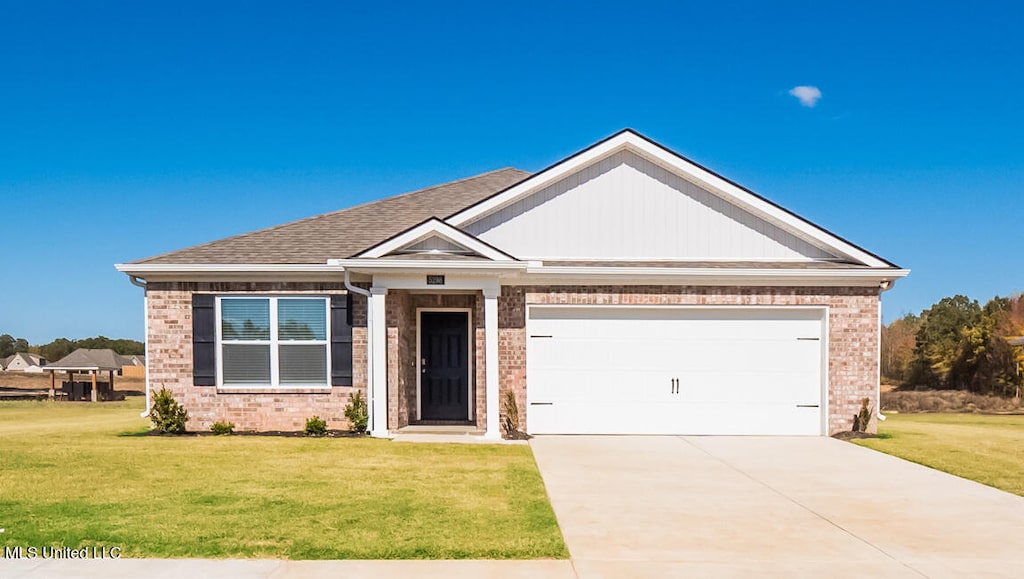 craftsman inspired home featuring a front yard and a garage