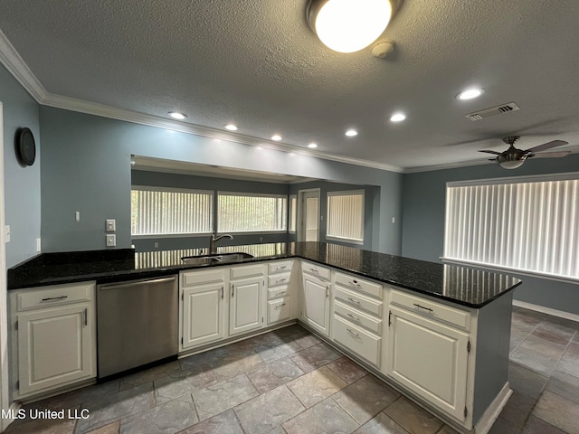 kitchen featuring dishwasher, kitchen peninsula, sink, white cabinets, and a textured ceiling