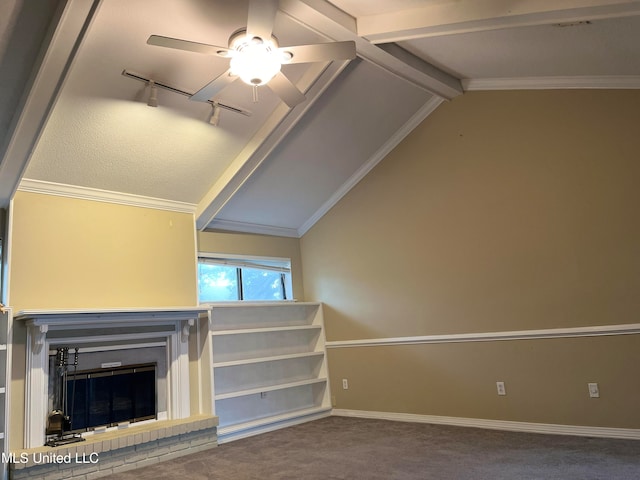 unfurnished living room featuring vaulted ceiling with beams, a fireplace, ornamental molding, carpet, and track lighting