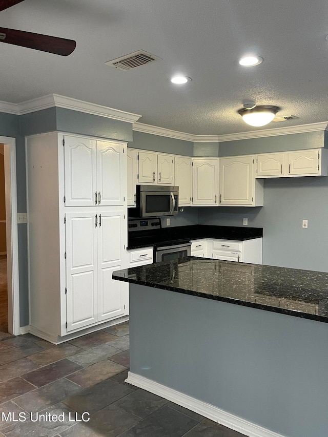 kitchen featuring ceiling fan, stainless steel appliances, white cabinets, dark stone countertops, and ornamental molding