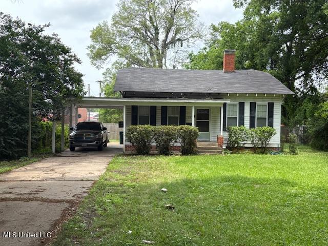 308 W Harding Ave, Greenwood, MS 38930 - view of front of property featuring a front lawn, a chimney, an attached carport, concrete driveway, and a porch