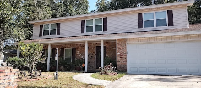 traditional-style house featuring brick siding, a porch, concrete driveway, and a garage