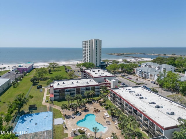 drone / aerial view of a nearby body of water and a pool