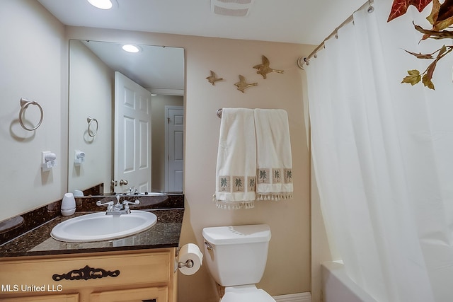 full bathroom featuring toilet, vanity, shower / bath combo, and recessed lighting