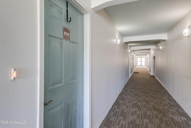 hall featuring baseboards