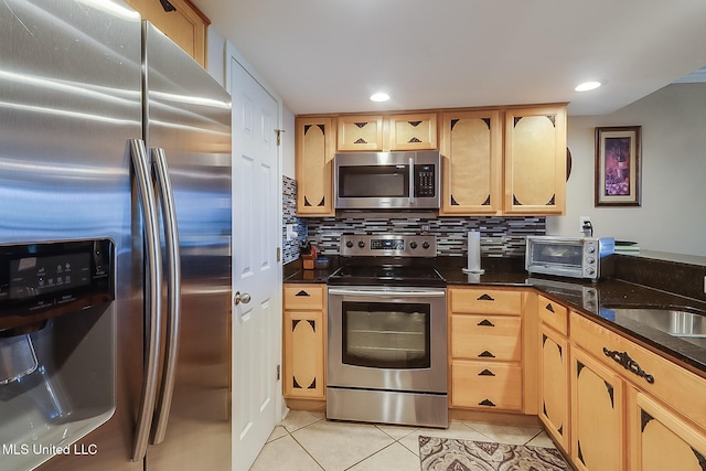 kitchen with stainless steel appliances, light tile patterned floors, light brown cabinetry, backsplash, and recessed lighting
