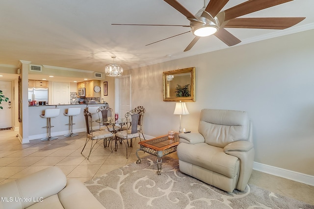 sitting room featuring light tile patterned floors, ornamental molding, ceiling fan, a chandelier, and baseboards