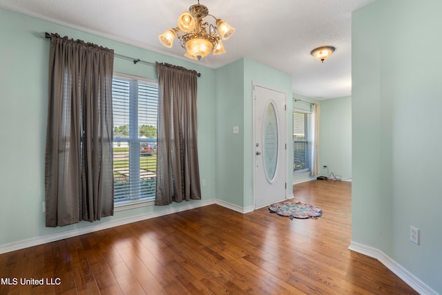 entryway featuring a chandelier and hardwood / wood-style flooring