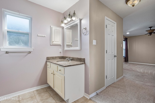 bathroom featuring vanity, a textured ceiling, and ceiling fan