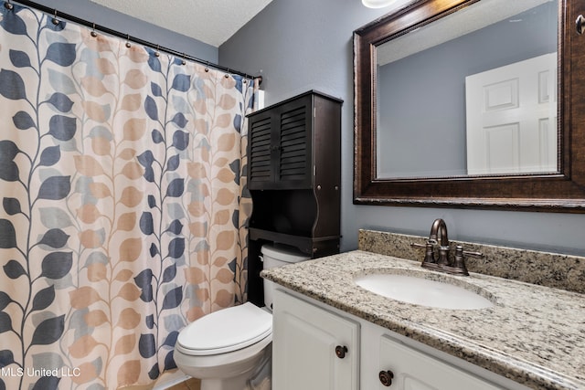 bathroom featuring vanity, a shower with curtain, a textured ceiling, and toilet